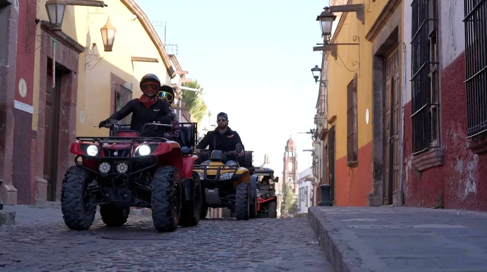 Experience Thrilling ATV Rentals in San Miguel de Allende with Guey Tours A group driving ATVs on the cobblestone streets of San Miguel de Allende during an adventure with Guey Tours.
